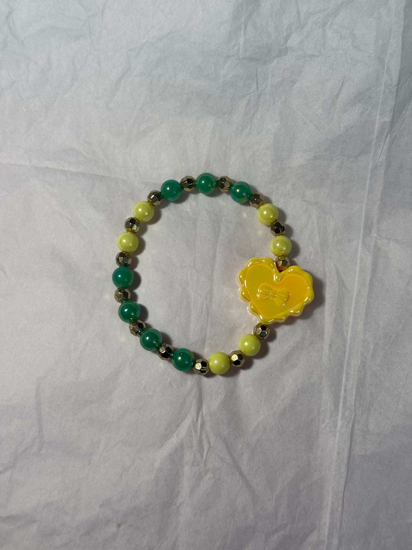 Green and yellow bracelet with heart charm