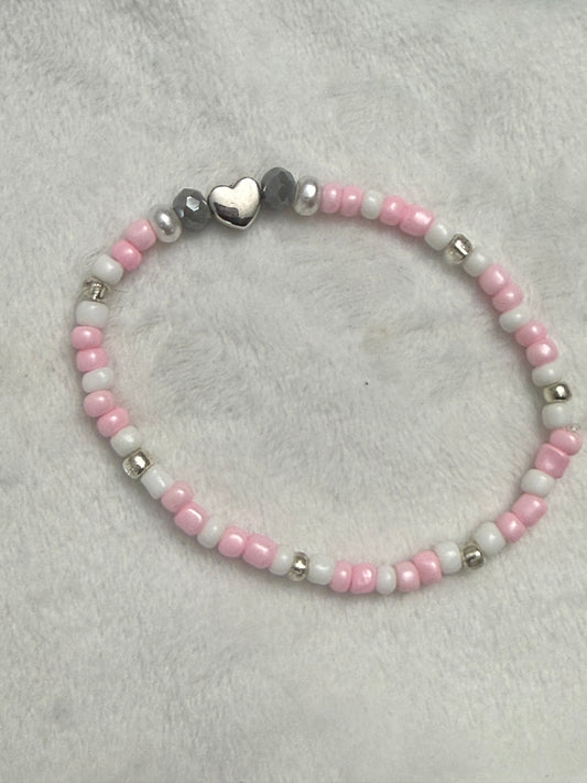 Pink seed bead bracelet with a silver charm