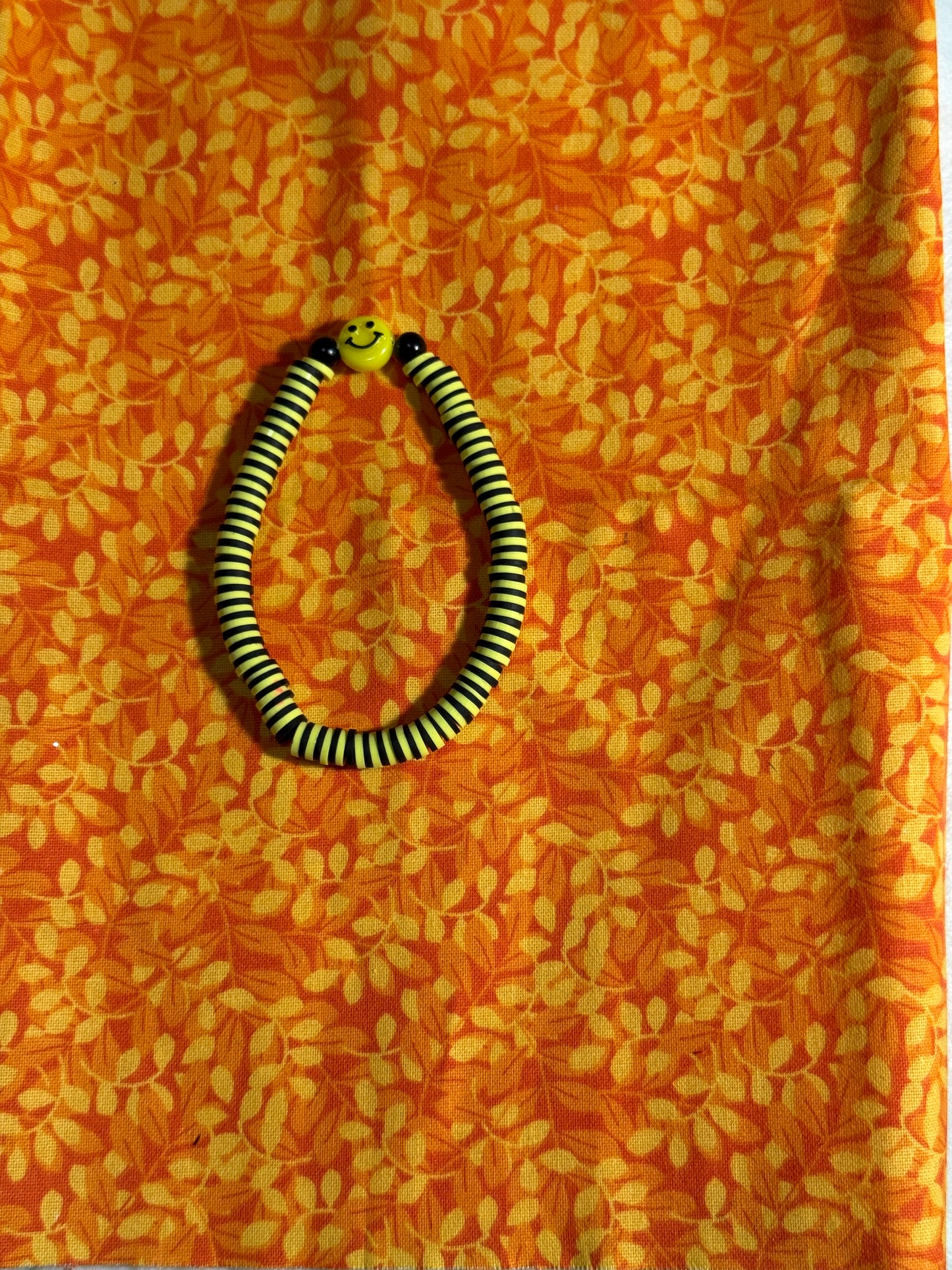 Yellow and black smiley face bracelet